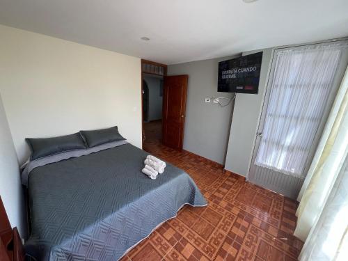 a bedroom with a bed with a towel on it at Apartamento Amplio con balcones Duitama in Duitama