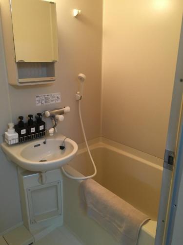 a bathroom with a sink and a bath tub at Apartment in Narita 225 in Narita