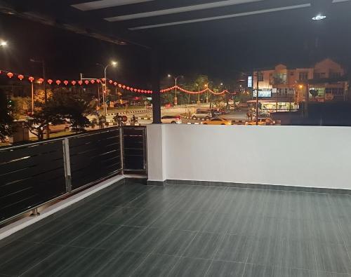 a balcony with a view of a city at night at SR Kampar 2-Storey LANDED HOMESTAY in Kampar