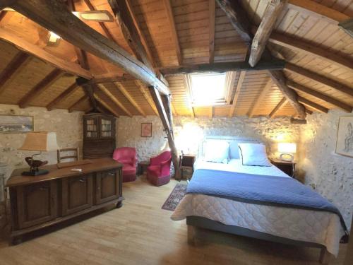a bedroom with a large bed and a wooden ceiling at Maison de charme à Brantôme, animaux admis, parking inclus - FR-1-616-461 in Brantôme