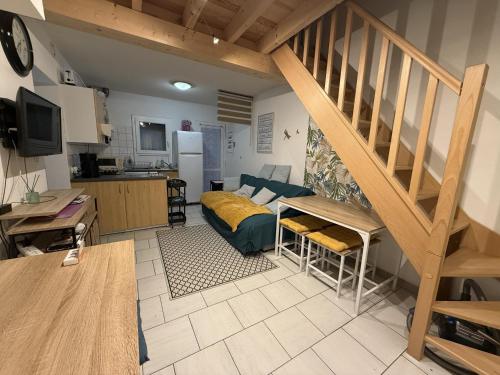 a living room with a staircase and a kitchen at Confort Famille dans Résidence avec Piscine - FR-1-778-39 in Dolus-d'Oléron