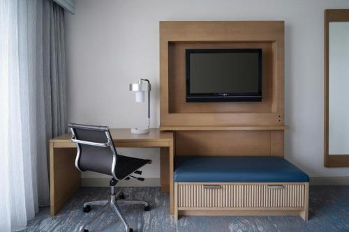 a room with a desk and a tv and a chair at Clearwater Beach Marriott Resort on Sand Key in Clearwater Beach