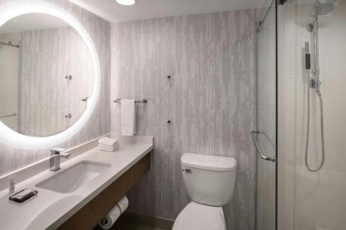 a bathroom with a toilet and a sink and a shower at Clearwater Beach Marriott Resort on Sand Key in Clearwater Beach