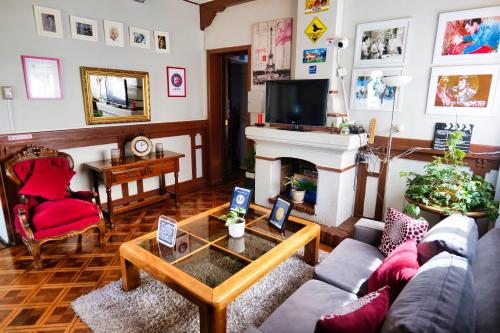 a living room with a couch and a fireplace at Hostal Boonen in Santiago