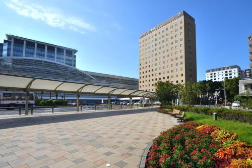 a walkway in the middle of a city with buildings at Hotel Urbic Kagoshima in Kagoshima