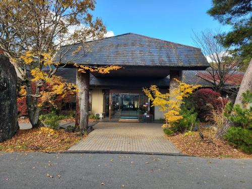 a building with a walkway in front of it at Aso Baien Spa Resort in Minami Aso