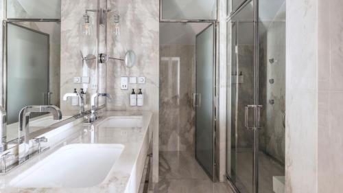 a bathroom with a sink and a shower at InterContinental Porto - Palacio das Cardosas by IHG in Porto
