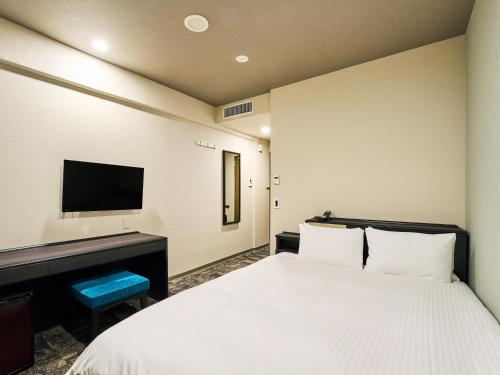 Ένα ή περισσότερα κρεβάτια σε δωμάτιο στο Hotel Elcient Kyoto Hachijoguchi
