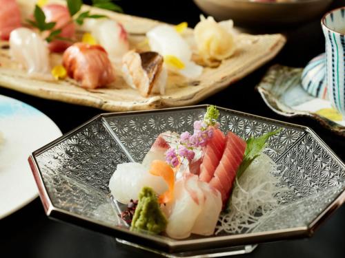 a plate of food with sushi on a table at Rembrandt Hotel Atsugi in Atsugi