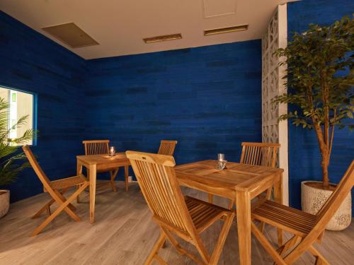 a dining room with two wooden tables and chairs at Rembrandt Hotel Atsugi in Atsugi