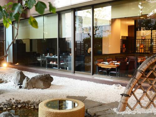 a restaurant with a bear sitting in front of a building at Rembrandt Hotel Atsugi in Atsugi