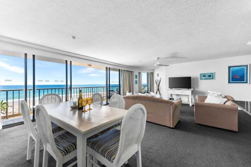 a living room with a table and chairs and a couch at The Rocks Resort Unit 5D in Gold Coast