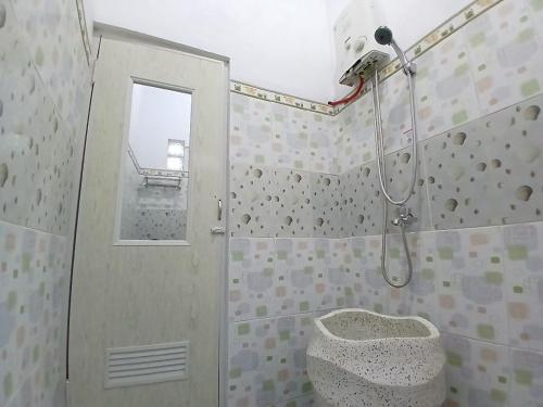 a bathroom with a shower with a toilet in it at D'Bondowoso Homestay Magelang RedPartner in Sumberrejo