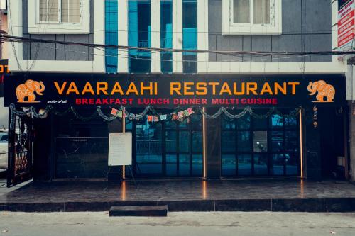 a sign for a restaurant in front of a building at Vaaraahi Hotels in Hyderabad