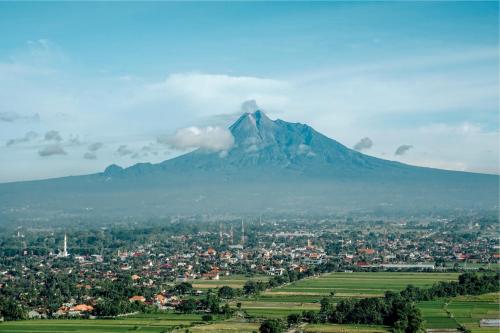 a view of a mountain with a town and a city at Amaranta Prambanan Yogyakarta in Yogyakarta