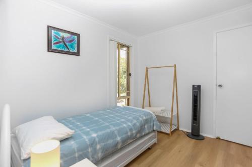 a bedroom with a bed and a mirror at Saltwater Retreat Hawks Nest in Hawks Nest