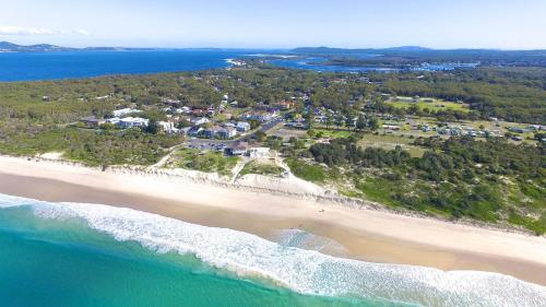 an aerial view of a beach with houses and the ocean at Saltwater Retreat Hawks Nest in Hawks Nest
