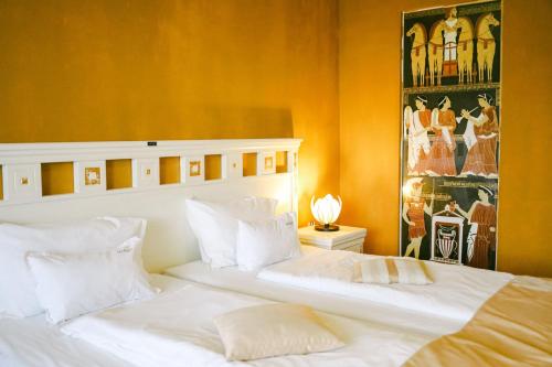 two white beds in a room with orange walls at Hotel Casa Art in Oreshak