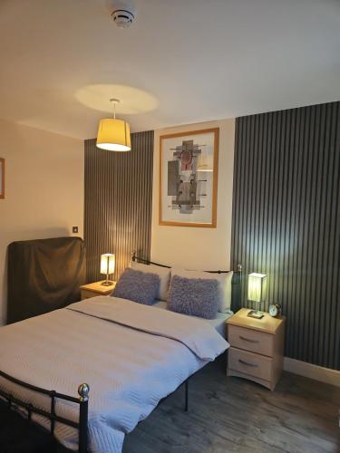 a bedroom with a large bed with two pillows at Luxury Apartment New Street Birmingham in Birmingham