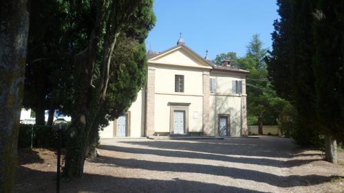 a large white house with trees in front of it at Hotel Villa San Donino in Città di Castello