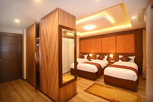 Postel nebo postele na pokoji v ubytování Hotel Sherpani
