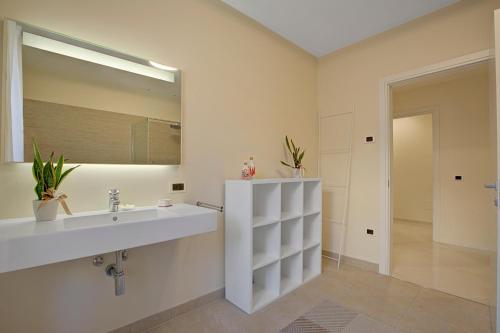 a bathroom with a sink and a mirror at Les Suites di Sara 3 and 5 - Happy Rentals in Riva del Garda