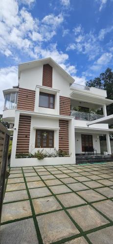 a large white house with at Reverie Homestay in Munroe Island