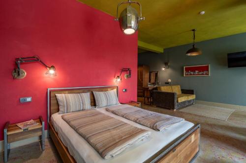 a bedroom with a large bed with a red wall at Hotel Casa Art in Oreshak