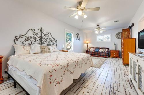 a bedroom with a bed and a ceiling fan at Walk to Downtown Shops and BBQ Home with Fenced Yard in Lockhart