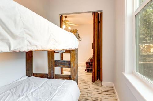 a bedroom with a bunk bed and a window at Walk to Downtown Shops and BBQ Home with Fenced Yard in Lockhart