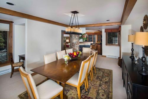 a dining room with a wooden table and chairs at Gravity Haus Vail in Vail