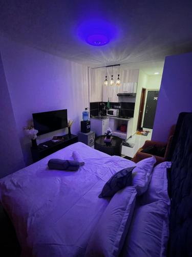 a purple bedroom with a bed and a living room at Luxore Apartments Syokimau No E311 in Nairobi
