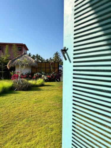 a view of a yard with a house at Casa Samudra - charming & spacious villa by the sea surrounded by nature in Selong Belanak
