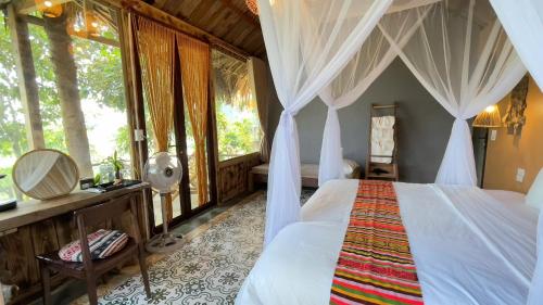 a bedroom with a bed with a canopy at Pu Luong Paradise in Hương Bá Thước