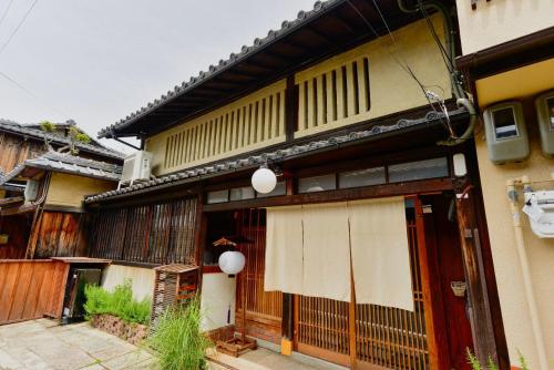 an old building with a gate in front of it at Kyoto HANATSUNAGI Hotel --- Kyoto city officially designated "KYO-MACHIYA" in Kyoto
