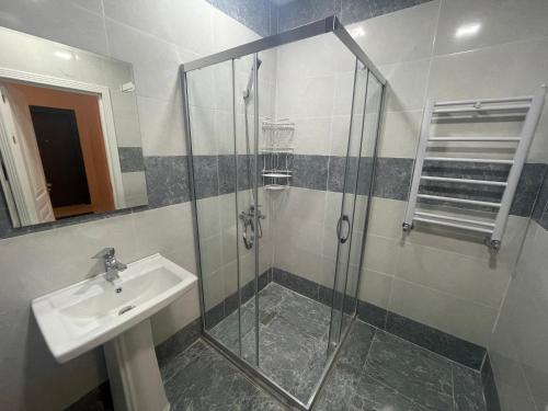 a bathroom with a sink and a shower at Caspian Mirvari in Sumqayyt