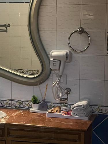 a bathroom counter with a hair dryer and a mirror at Villa 33 in New Delhi