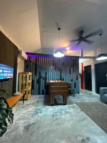 a room with a pool table and a ceiling fan at Kerlingfornia Pond View Homestay in Kerling