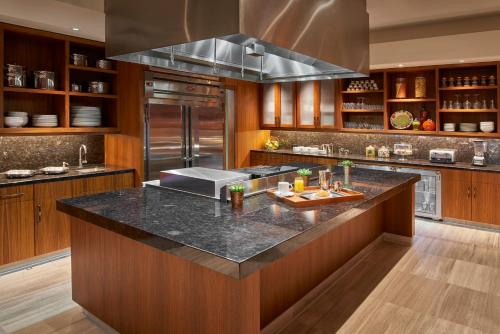 a kitchen with a large island with a counter top at The Clement Hotel in Palo Alto