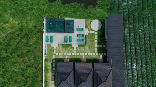 an aerial view of a house with a pool at D Sila's Tepi Danu Villas Kintamani & Natural hot spring in Kintamani