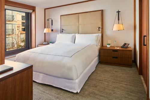 sypialnia z dużym białym łóżkiem i oknem w obiekcie The Clement Hotel - All Inclusive Urban Resort w mieście Palo Alto