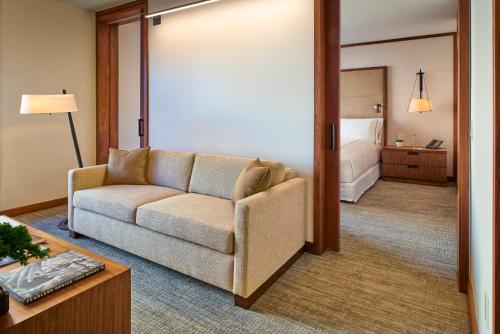a living room with a couch and a bedroom at The Clement Hotel in Palo Alto