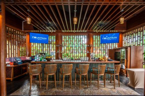 a bar in a restaurant with chairs and windows at Hyatt Regency Hua Hin in Hua Hin
