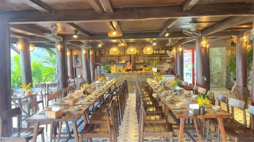 a large dining room with long tables and chairs at Pu Luong Paradise in Hương Bá Thước