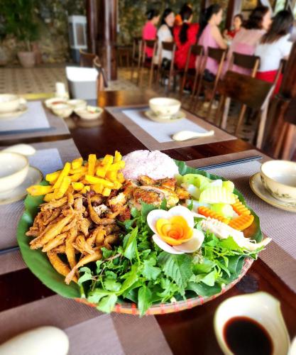 a plate of food on a table with a salad at Pu Luong Paradise in Hương Bá Thước