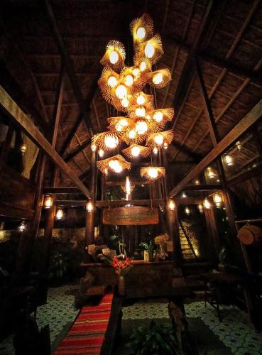 a large chandelier hanging from a wooden ceiling at Pu Luong Paradise in Hương Bá Thước