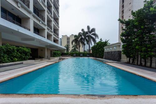a swimming pool in the middle of a building at La Breza Hotel in Manila