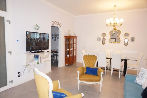 a living room with a dining room table and chairs at Viareggio, Sweet home in Viareggio