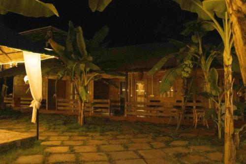 a building at night with trees in front of it at Rosa Mystica in Cola