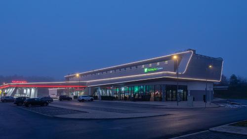a gas station with cars parked in front of it at Holiday Inn Express - Hamburg South A7-AS42 by IHG in Egestorf